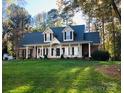 Attractive two-story home with a covered front porch, set on a well-maintained lawn at 390 Robinson Rd, Mooresville, NC 28117