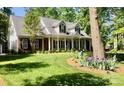 Delightful two-story home featuring a cozy front porch and a beautifully manicured lawn at 390 Robinson Rd, Mooresville, NC 28117