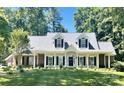 Charming exterior of a bright home with a manicured lawn and inviting front porch at 390 Robinson Rd, Mooresville, NC 28117