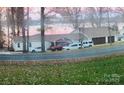 Charming lakefront home with a three-car garage and driveway parking for multiple vehicles at 390 Robinson Rd, Mooresville, NC 28117