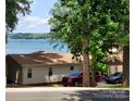 This lakeside property provides access to water views from a home with a private driveway and parking at 390 Robinson Rd, Mooresville, NC 28117