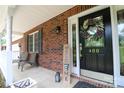 Charming front porch featuring a welcome sign, chairs, and brick accents at 400 Majolica Rd, Salisbury, NC 28147