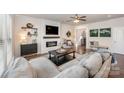 Elegant living room with shiplap fireplace, floating shelves, and designer furniture at 4012 Woodsmill Rd, Fort Mill, SC 29707