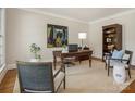 Classic office with a large wooden desk, chairs, and built-in bookshelves at 4026 Sharon View Rd, Charlotte, NC 28226