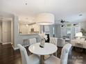 Open-concept dining area with a modern light fixture and a view of the kitchen at 416 Queens Rd # 10, Charlotte, NC 28207
