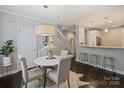 Cozy dining area featuring hardwood floors, a modern light fixture and barstool seating at kitchen counter at 416 Queens Rd # 10, Charlotte, NC 28207