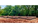 The brick foundation of the new home shows progress on the home site at 5053 Carolina Dr, Gastonia, NC 28056
