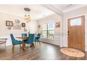 An inviting dining room with wood floors, stylish lighting, and a view from the window at 5092 Nighthawk Dr, Indian Land, SC 29707