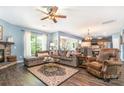 Spacious living room featuring a stone fireplace, hardwood floors, and a comfortable seating arrangement at 5092 Nighthawk Dr, Indian Land, SC 29707