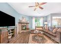 Cozy living room with a stone fireplace, ceiling fan, and comfortable seating arrangement at 5092 Nighthawk Dr, Indian Land, SC 29707