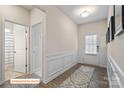 Inviting entryway featuring wood-look floors, white trim, and access to the bathroom at 523 Hullview Vis, Monroe, NC 28110