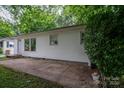 A quaint home featuring a concrete patio, white siding, and trimmed bushes at 535 Norman Fair Ave, Lincolnton, NC 28092
