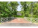 Stunning home featuring a brick bridge with scenic views leading to the picturesque estate at 704 Little Creek Dr, Kings Mountain, NC 28086