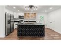 A modern kitchen with stainless appliances, sleek countertops, a geometric black island, and ample cabinet space at 704 W Border St, Dallas, NC 28034