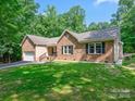 A single-story brick home showcases manicured lawns and shaded greenery at 7300 Bailywick Dr, Waxhaw, NC 28173