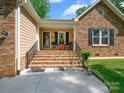Inviting front porch with brick stairs and charming seating area at 7300 Bailywick Dr, Waxhaw, NC 28173