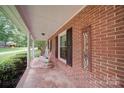 Cozy front porch with brick siding, rocking chairs, and a 'Welcome' sign, inviting relaxation and southern charm at 734 Forestbrook Dr # 10, Gastonia, NC 28056