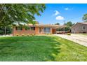 Well-maintained home with an attached carport and a lush green lawn at 888 Stowe Ln, Gastonia, NC 28056