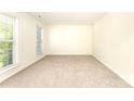 Bright bedroom with neutral carpet, clean walls, and natural light from two windows at 9146 Austin Ridge Ln, Charlotte, NC 28214