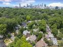 Aerial view of a neighborhood near the city, featuring mature trees, well-maintained homes, and a vibrant green landscape at 1021 Isleworth Ave, Charlotte, NC 28203