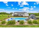 Backyard pool with a slide, lounge chairs, and manicured landscaping at 106 Laren Rd, Shelby, NC 28152