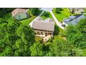 Aerial shot of backyard oasis, complete with a cozy patio and inviting fire pit nestled among mature trees at 110 St Sophia Ct, Mooresville, NC 28117