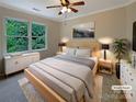 Cozy staged bedroom with a large window, soft carpet, and neutral decor at 12092 Spinnaker Dr, Fort Mill, SC 29708