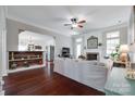 Cozy living room featuring a fireplace, dark wood floors, and open access to kitchen at 12311 Bentcreek Ln, Matthews, NC 28105