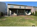 Enjoy this backyard with a covered patio, outdoor curtains, ceiling fan and hammock at 150 Haddonsfield Dr, Mooresville, NC 28115
