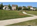 View of the community park with sidewalks, mature trees and a gazebo at 150 Haddonsfield Dr, Mooresville, NC 28115