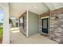 A welcoming front porch featuring stone accents and a stylish front door at 150 Haddonsfield Dr, Mooresville, NC 28115