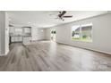 Bright living room with laminate floors, recessed lighting, and large windows offering ample natural light at 1709 White Willow Ave, Gastonia, NC 28054