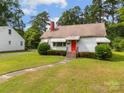 A charming home with a red door, green lawn, and separate garage at 216 Hillcrest Pl, Salisbury, NC 28144