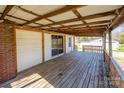 Large wooden back deck with a covered overhead and views of the backyard at 260 Penninger Dr, Woodleaf, NC 27054