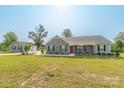 Sprawling property with a well-manicured lawn, detached garage, and a charming single-story home with a inviting front porch at 2737 Bobcat Rd, Heath Springs, SC 29058