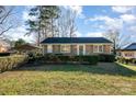 Charming brick home features a well-manicured front yard and lush green hedges, perfect for curb appeal at 2809 Markland Dr, Charlotte, NC 28208