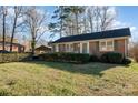A well-maintained brick house with neat landscaping and a convenient carport, showcasing suburban charm at 2809 Markland Dr, Charlotte, NC 28208