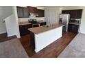 Well-equipped kitchen featuring dark cabinets, stainless steel appliances, and a kitchen island at 3014 Green Apple Dr, Dallas, NC 28034