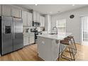 Bright kitchen with white cabinets, stainless steel appliances, and an island with seating at 3108 Beeler Ln, Charlotte, NC 28208