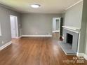 Spacious living room boasts hardwood floors and a striking fireplace, perfect for cozy gatherings and comfortable living at 3217 Celanese Rd, Rock Hill, SC 29732