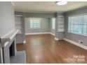 Expansive living room featuring hardwood floors, built-in bookshelves, and large windows that fill the space with natural light at 3217 Celanese Rd, Rock Hill, SC 29732
