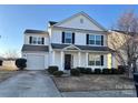 Charming two-story home with a well-maintained front yard, attached garage, and classic curb appeal at 3244 Oulten Sw St, Concord, NC 28027