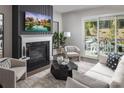 Bright living room featuring a fireplace, sliding glass doors to patio, and neutral decor, perfect for relaxing or entertaining guests at 4146 Eastover Glen Rd # 0322, Charlotte, NC 28269