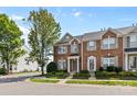 Inviting brick townhome with neat landscaping, featuring classic architectural details at 4208 Coulter Xing, Charlotte, NC 28213