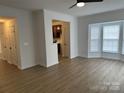 Bright living room with fan and doorway to kitchen offers lots of natural light from large bay window at 4208 Coulter Xing, Charlotte, NC 28213