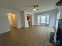 Spacious living room features bay window for lots of natural light and access to kitchen at 4208 Coulter Xing, Charlotte, NC 28213
