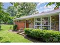 Charming home with a brick and stone facade, well-manicured lawn, and lush landscaping at 4232 Randolph Rd, Charlotte, NC 28211