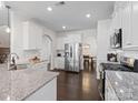 Modern kitchen with stainless steel appliances, granite countertops, white cabinets, and hardwood floors at 4310 Coachwhip Ave, Lancaster, SC 29720
