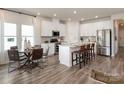 Modern kitchen featuring stainless steel appliances, a large island, and a cozy dining area at 438 Bent Burr Crk, York, SC 29745