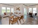 Open concept living room with plenty of natural light, elegant furniture, and hardwood flooring at 438 Bent Burr Crk, York, SC 29745